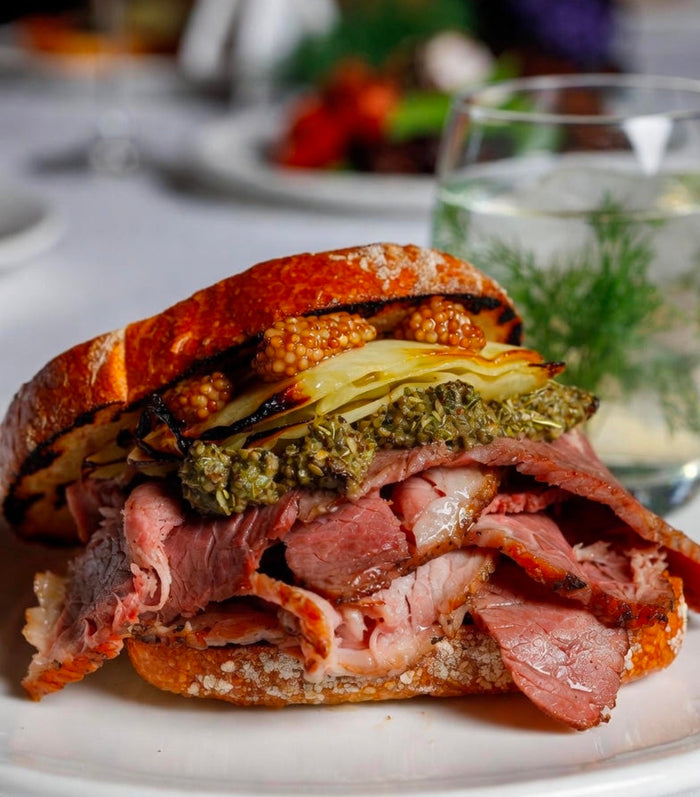 48-Hour Sous-Vide Wagyu Brisket Pastrami with Infused Rye Caraway Butter, Charred Cabbage, and Dill-Pickled Mustard Seeds